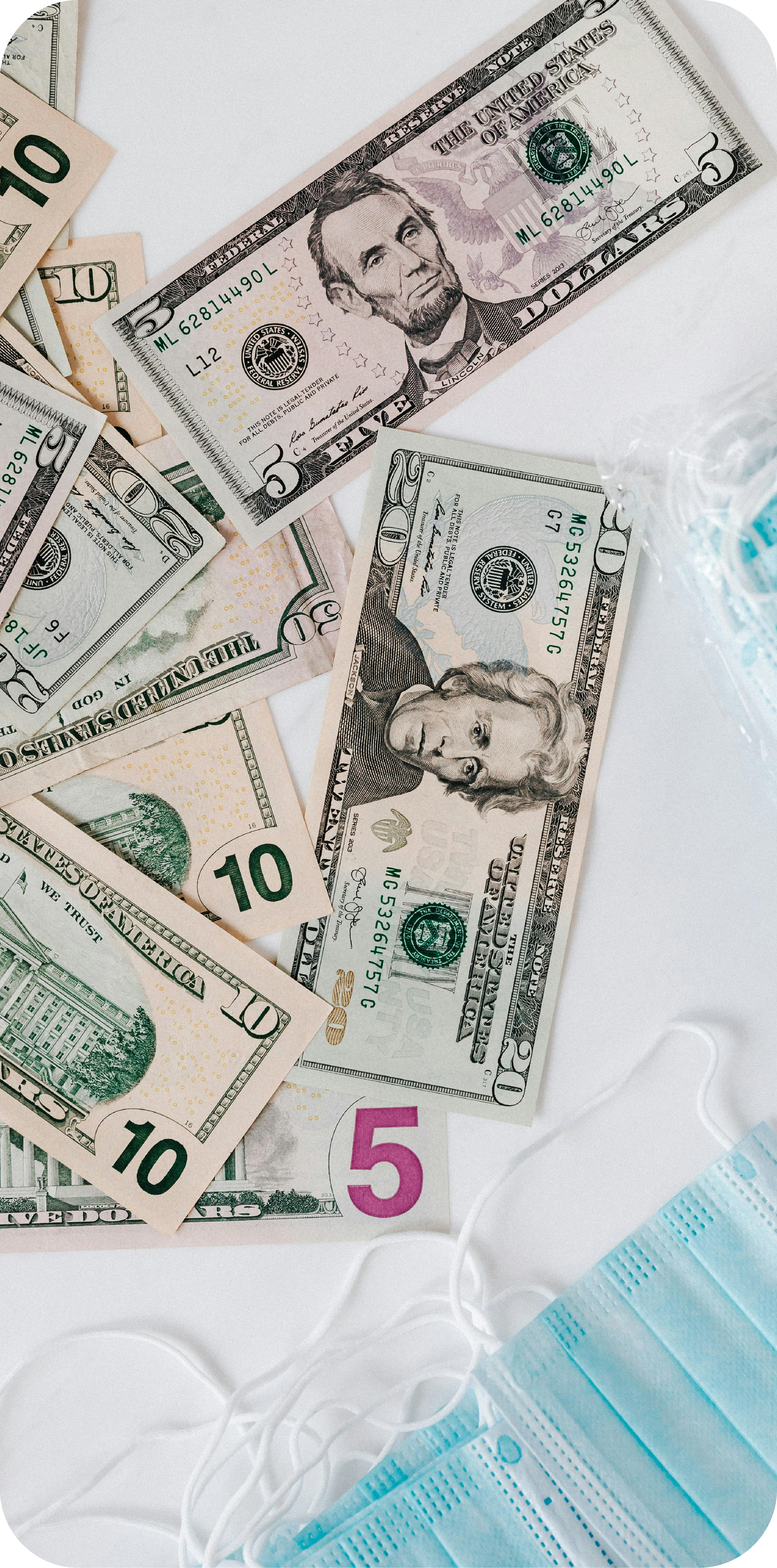 An image of loose US bills and surgical masks.